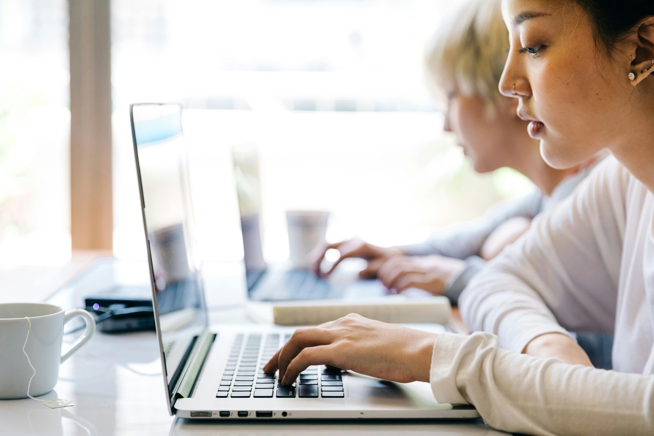 A woman reviewing her college application on a computer.