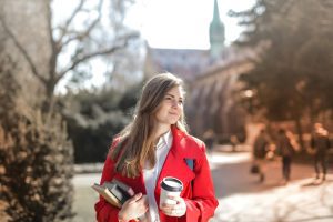 A young woman walking to an interview at a college campus.