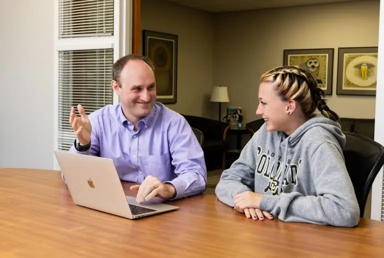 A literature tutor helping a high school student with their homework.