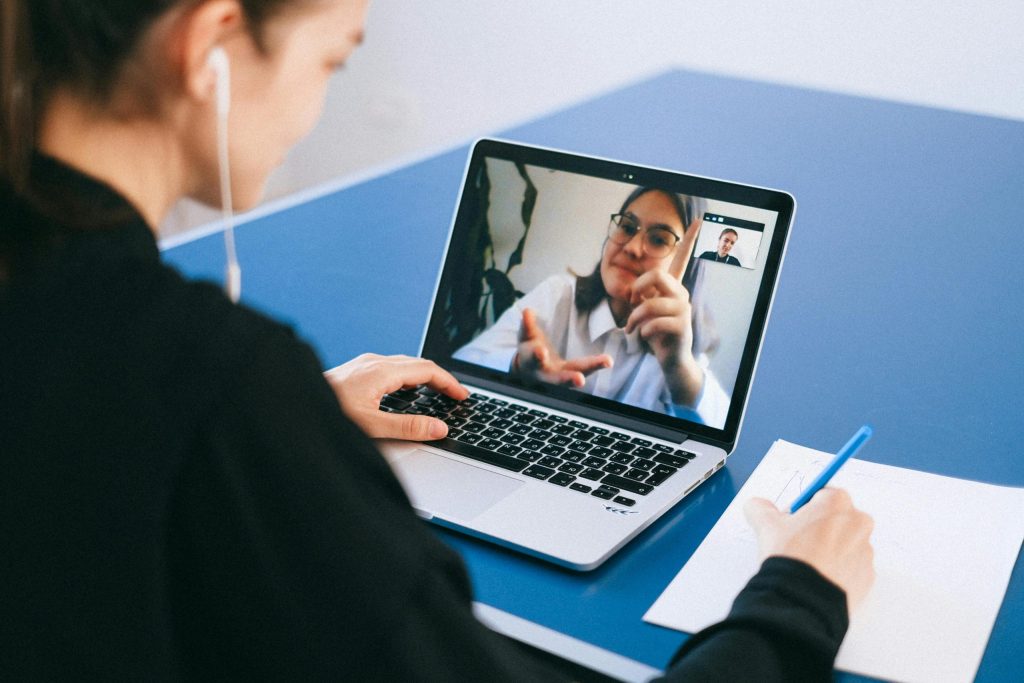 A tutor explaining concepts on the MCAT to a student in a virtual meeting.