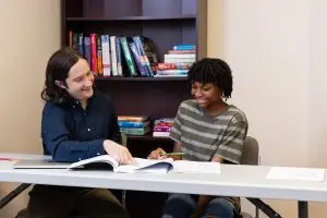 A student working with a tutor to prepare for the SAT or ACT®.